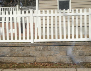 stone wall with fencing installed residential