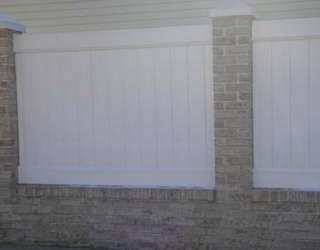 brick wall with fencing installed