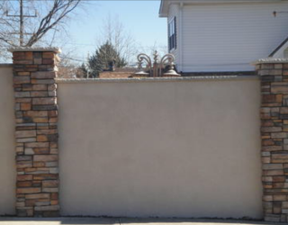 stucco wall with stone columns installed