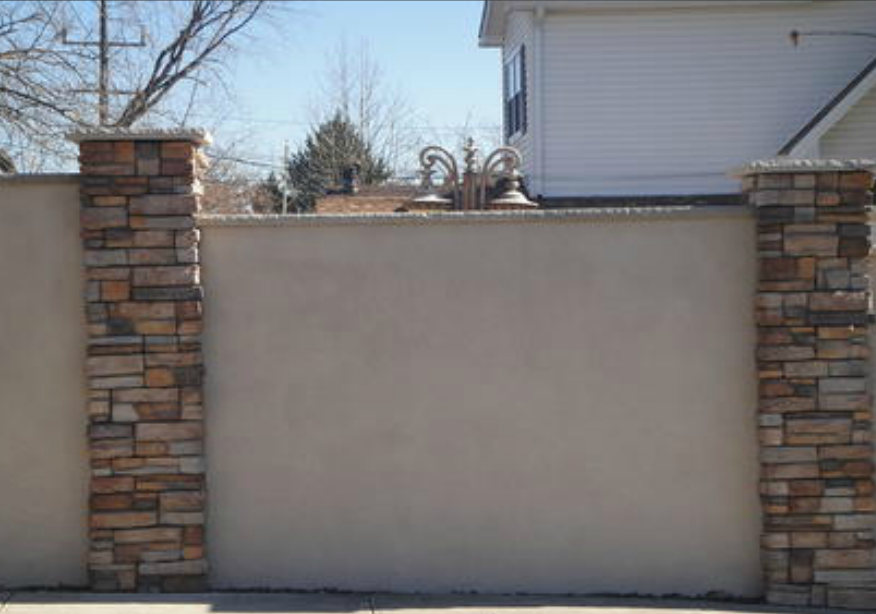 stucco wall with stone columns installed