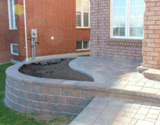 stone wall and walkway installed with garden