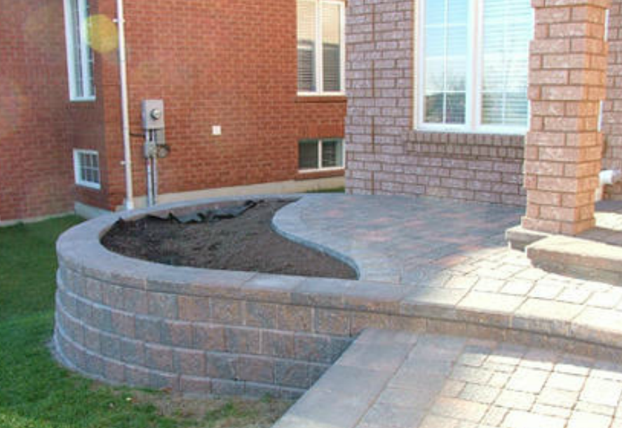 stone wall and walkway installed with garden