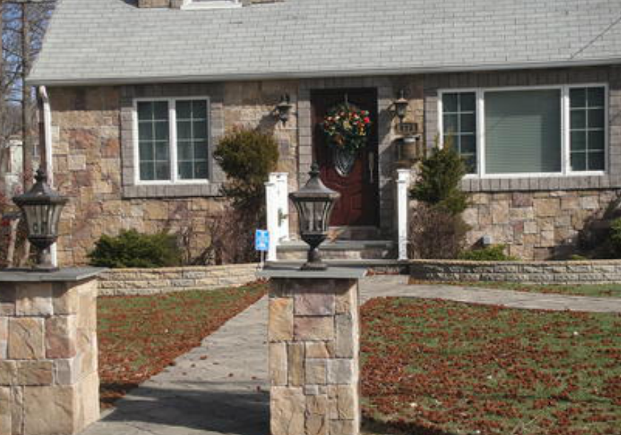 flag stone walkway and stone face house residential