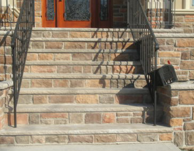 cultured stone stairway in front of house installed by pavers